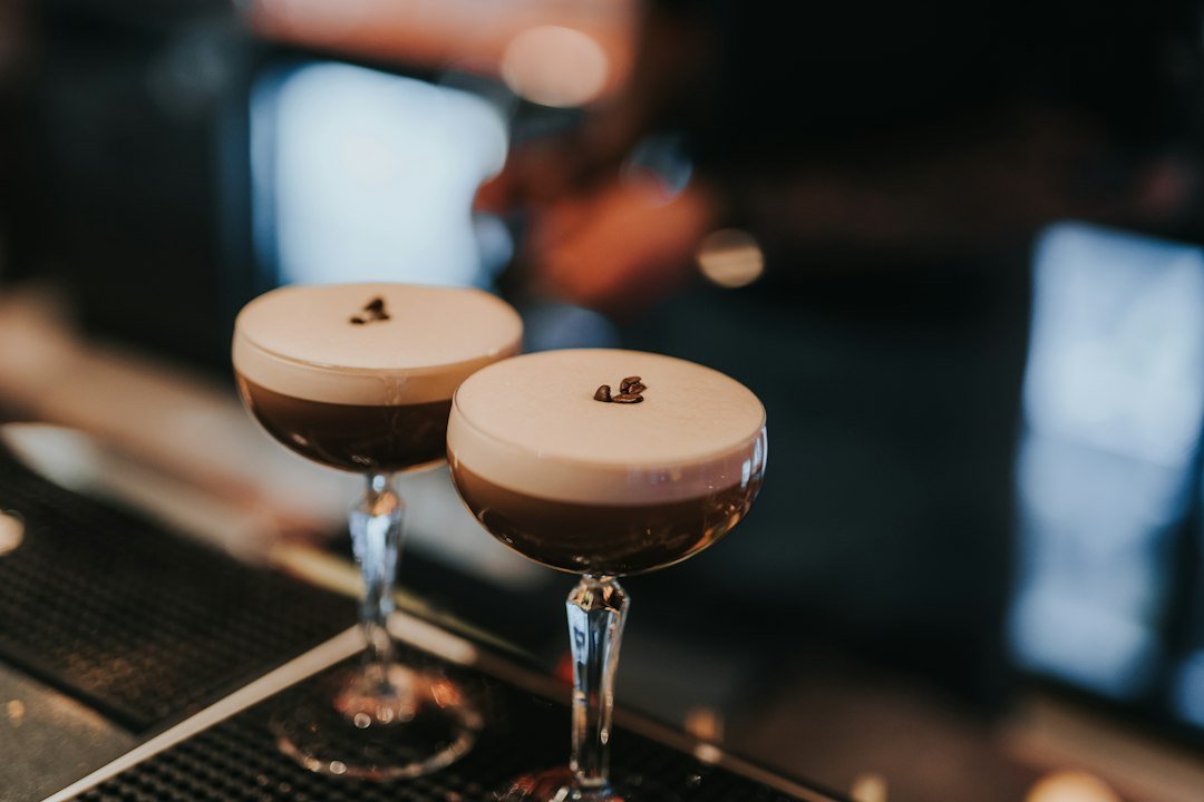 A perfectly made espresso martini with thick crema foam and three coffee beans on top, cocktail recipes NZ style