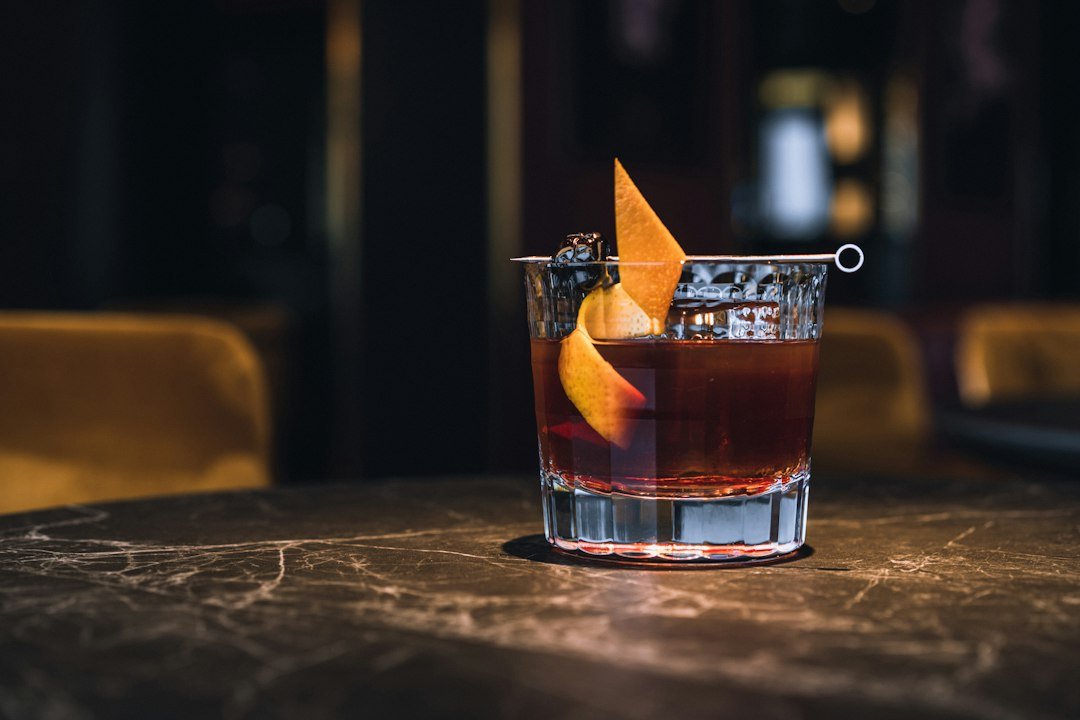 A classic Negroni cocktail recipe served over ice in a rocks glass with an orange peel garnish, made with gin and Campari