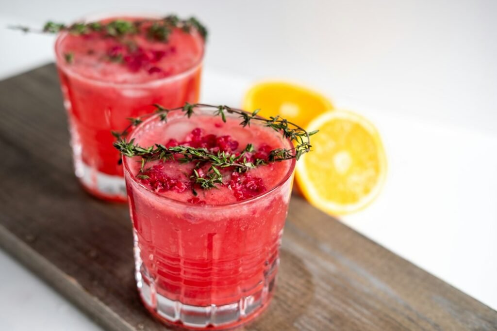 A zero-proof Negroni mocktail in a rocks glass with an orange peel garnish, made using easy mocktail recipes nz style